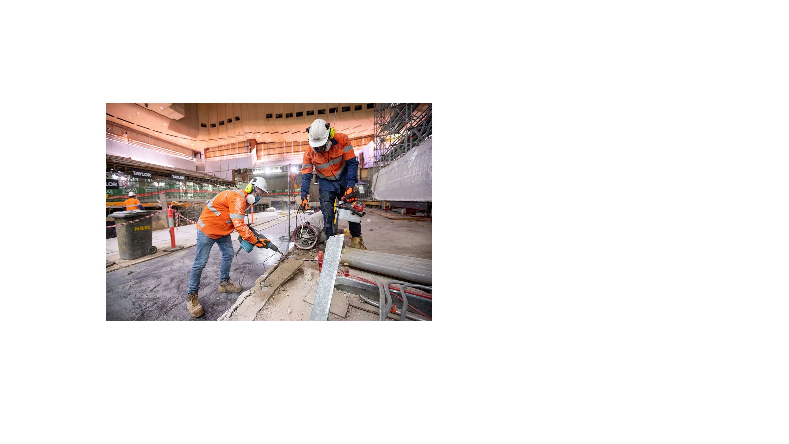 Image of two construction works drilling and sawing in the Concert Hall construction site