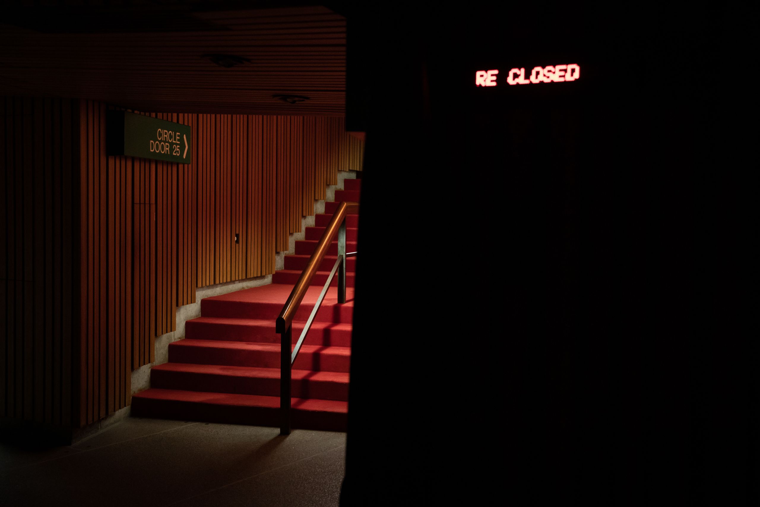 Red staircase, with a sign in background reading 'Circle, Door 25'